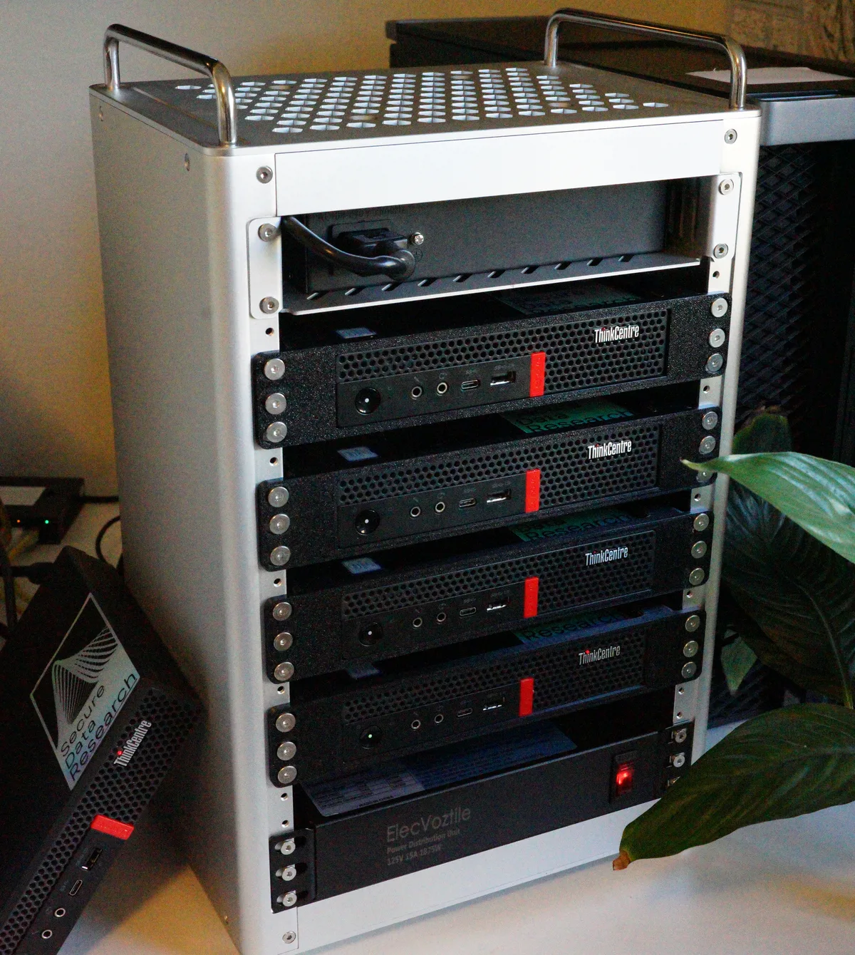 four machines racked in a portable aluminium frame